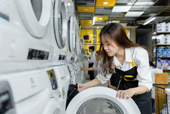 Laundry staff loading a washing machine